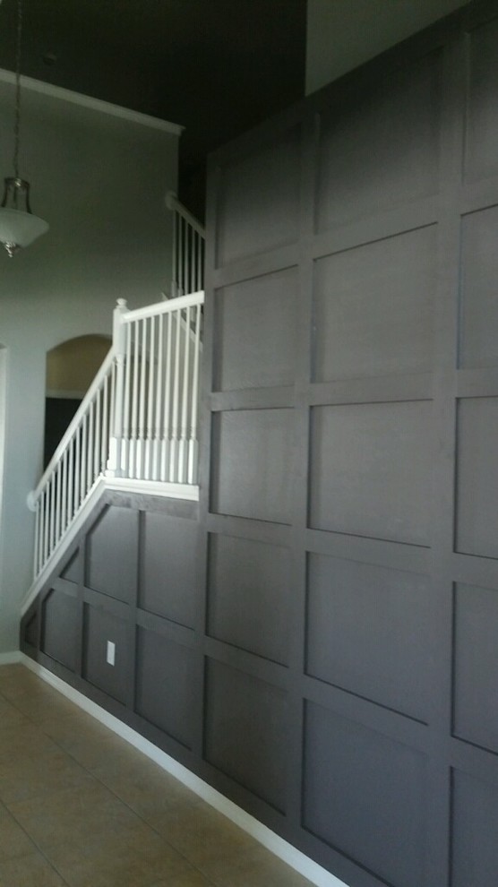 This is an example of a mid-sized transitional hallway in Tampa with grey walls, carpet and brown floor.