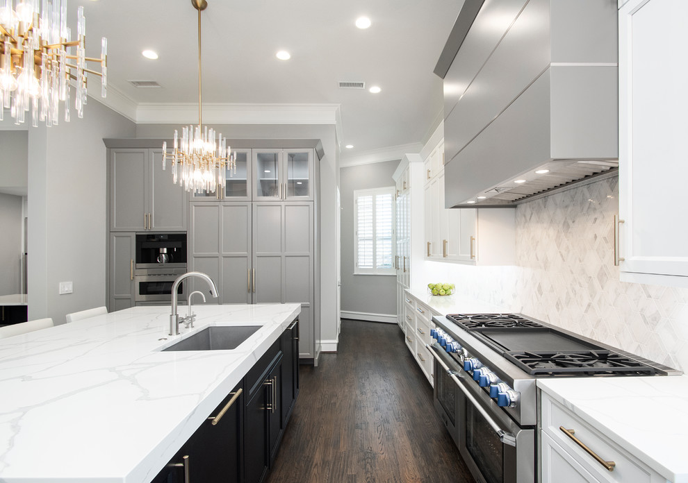 This is an example of a large contemporary u-shaped kitchen pantry in Dallas with a single-bowl sink, flat-panel cabinets, grey cabinets, quartz benchtops, grey splashback, marble splashback, dark hardwood floors, with island, brown floor, white benchtop and panelled appliances.