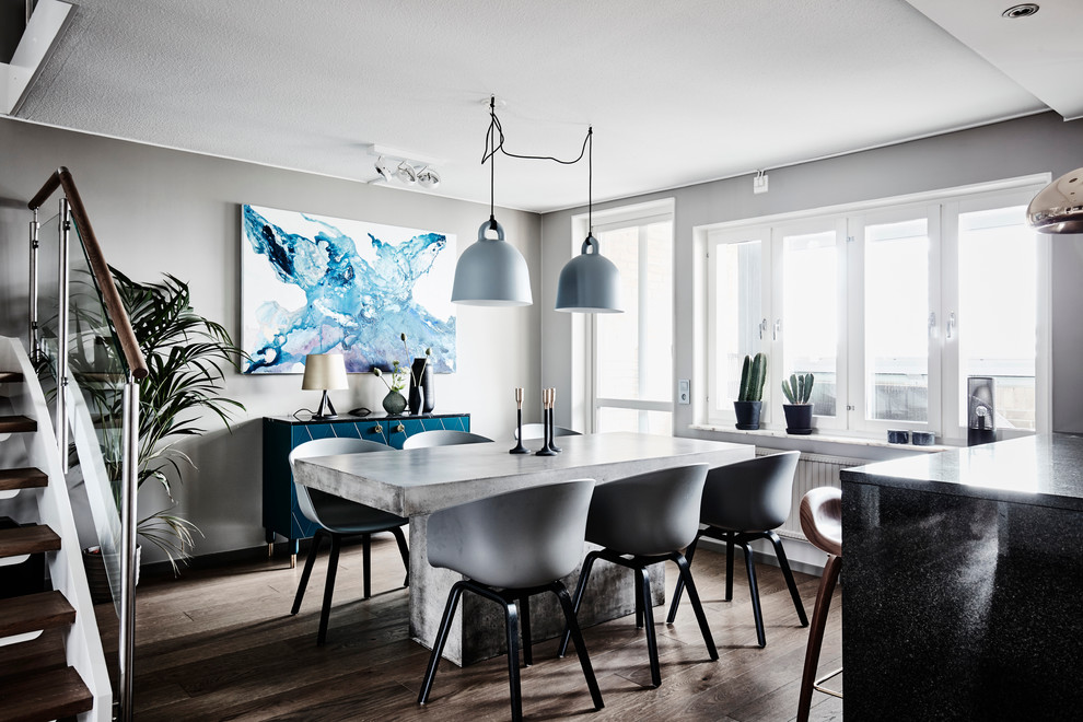 Photo of a mid-sized contemporary kitchen/dining combo in Gothenburg with grey walls, dark hardwood floors and brown floor.