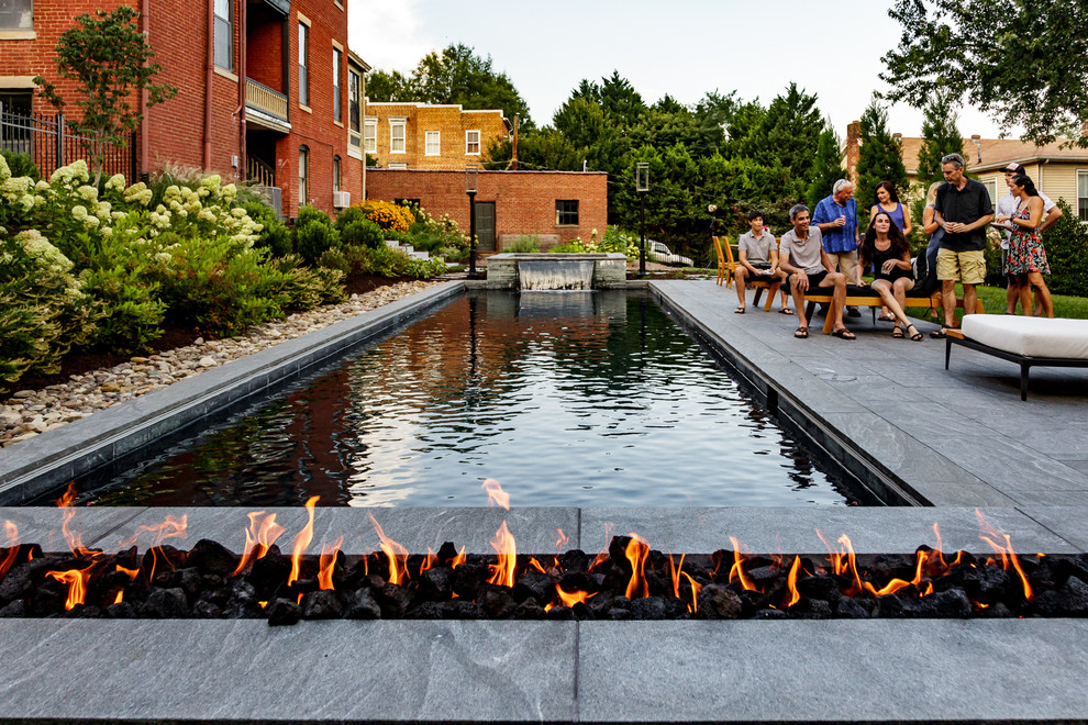 Backyard stone and rectangular hot tub photo