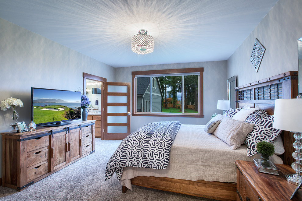 This is an example of a mid-sized arts and crafts master bedroom in Seattle with beige walls and carpet.