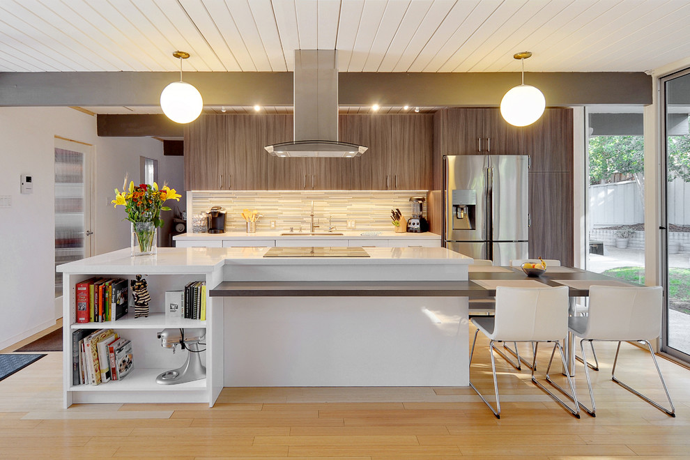 Inspiration for a contemporary galley open plan kitchen in San Francisco with a double-bowl sink, matchstick tile splashback, stainless steel appliances and with island.