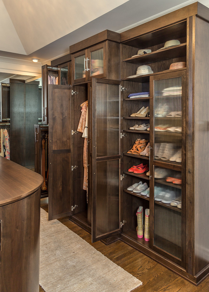 Design ideas for a large arts and crafts gender-neutral dressing room in Louisville with shaker cabinets, dark wood cabinets, medium hardwood floors and brown floor.
