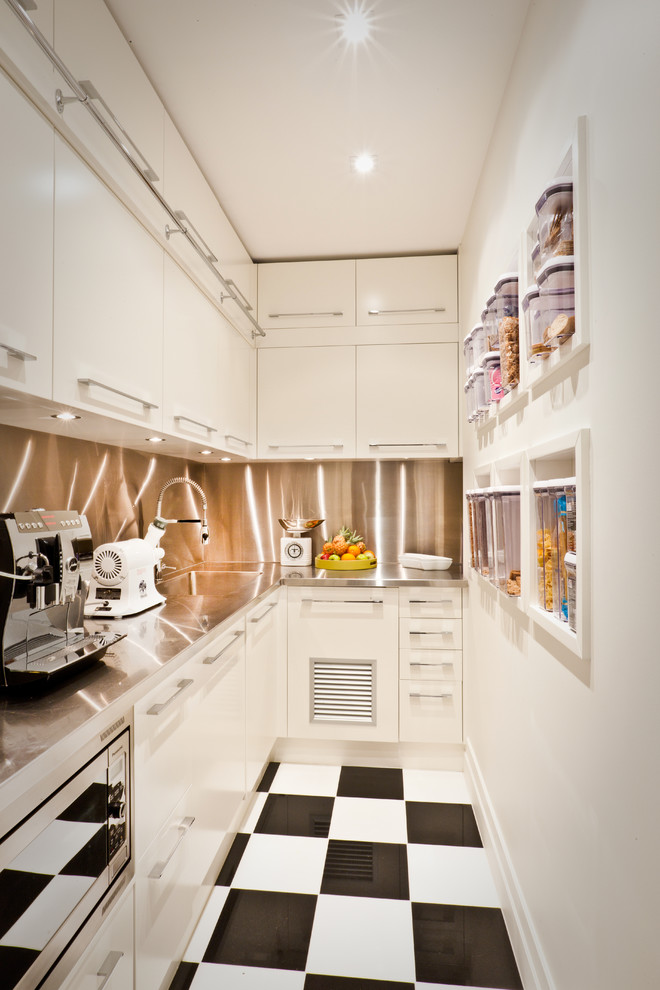 This is an example of a contemporary kitchen pantry in Gold Coast - Tweed with flat-panel cabinets, white cabinets and stainless steel appliances.