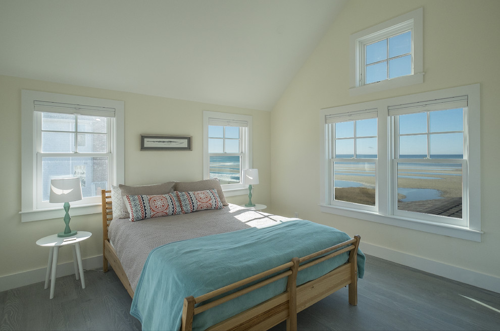 This is an example of a mid-sized beach style master bedroom in Boston with white walls, medium hardwood floors and no fireplace.
