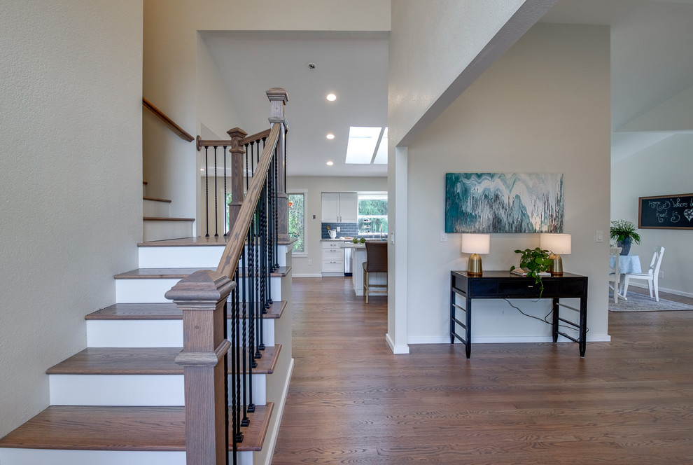 Foyer - mid-sized transitional medium tone wood floor and brown floor foyer idea in Orange County with white walls and a blue front door