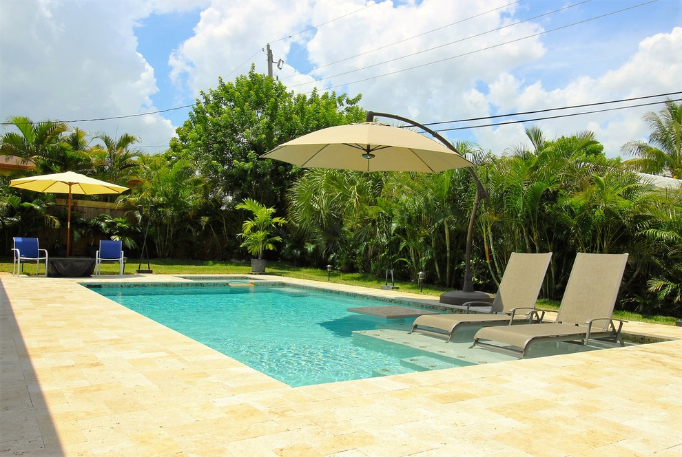 Pool fountain - mid-sized transitional backyard stone and custom-shaped pool fountain idea in Miami