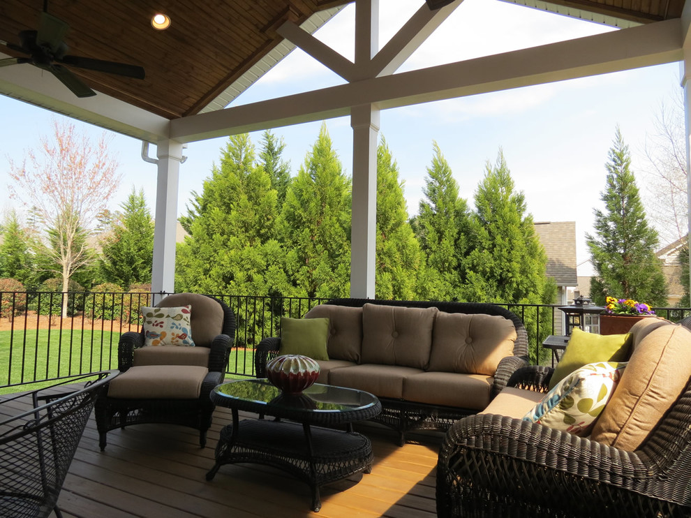 Inspiration for a mid-sized contemporary backyard deck in Charlotte with a roof extension.