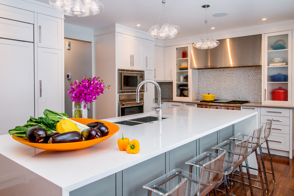 Large transitional l-shaped medium tone wood floor eat-in kitchen photo in Calgary with an undermount sink, shaker cabinets, white cabinets, quartz countertops, multicolored backsplash, mosaic tile backsplash, paneled appliances and an island