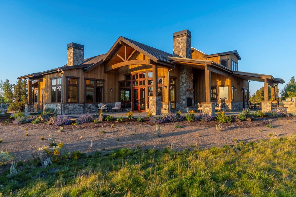Large mountain style brown two-story wood gable roof photo