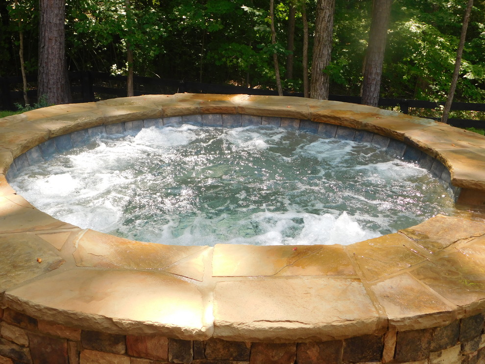 Mid-sized country backyard custom-shaped natural pool in Atlanta with a hot tub and brick pavers.