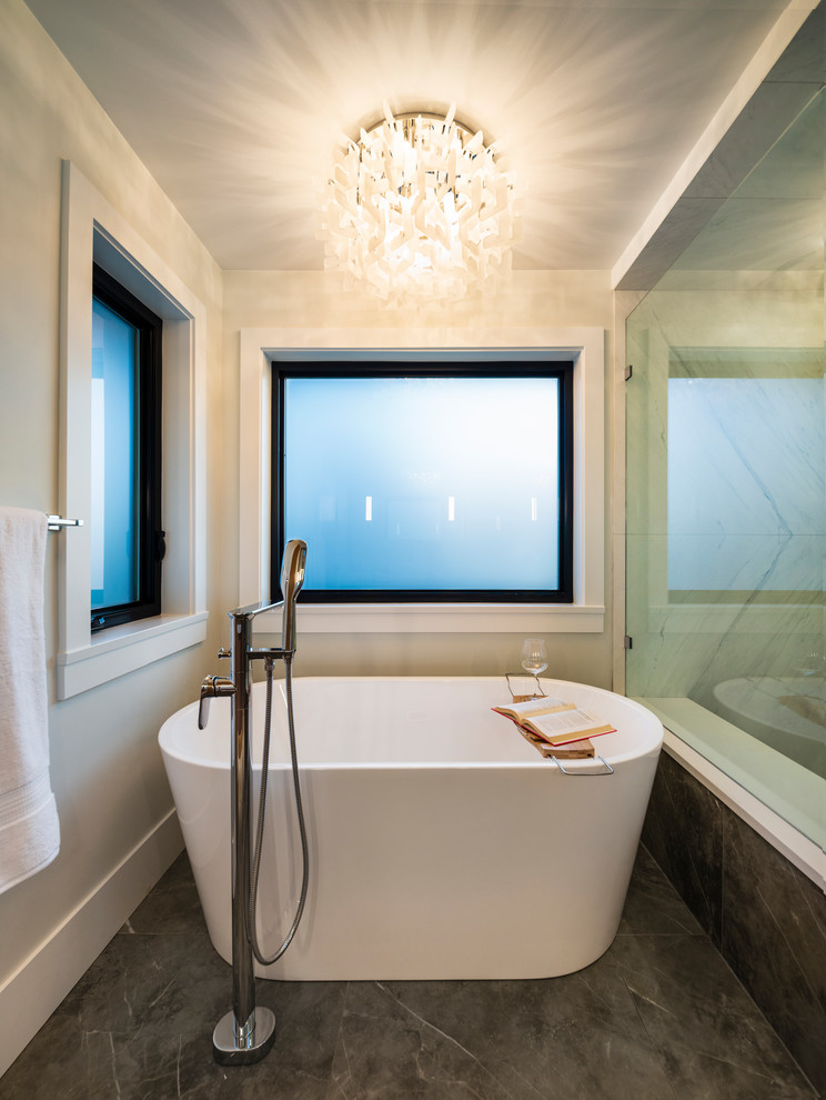 Large contemporary master bathroom in Vancouver with flat-panel cabinets, medium wood cabinets, a freestanding tub, a corner shower, a one-piece toilet, white tile, ceramic tile, white walls, porcelain floors, an undermount sink, engineered quartz benchtops, grey floor, a hinged shower door and white benchtops.
