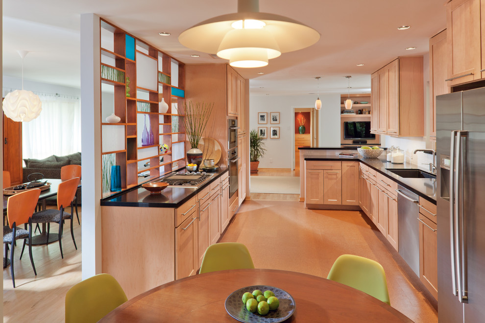 Photo of a mid-sized midcentury u-shaped eat-in kitchen in Other with a single-bowl sink, shaker cabinets, light wood cabinets, quartzite benchtops, white splashback, stainless steel appliances, a peninsula and beige floor.