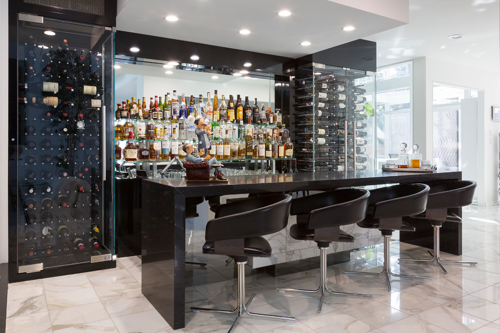 Inspiration for a contemporary galley seated home bar in Other with mirror splashback and white floor.