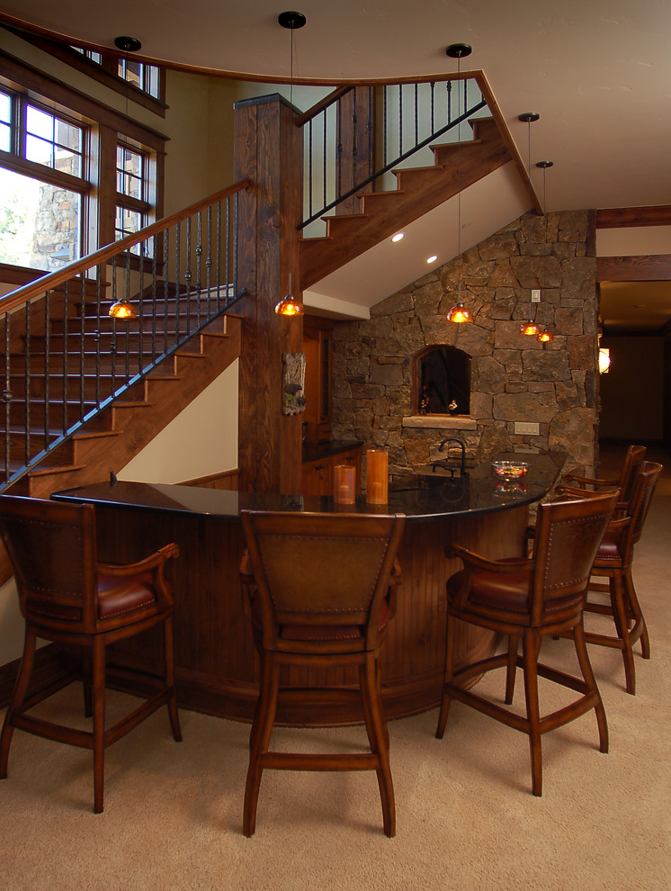 Large traditional u-shaped seated home bar in Denver with an undermount sink, raised-panel cabinets, medium wood cabinets, granite benchtops, carpet and beige floor.
