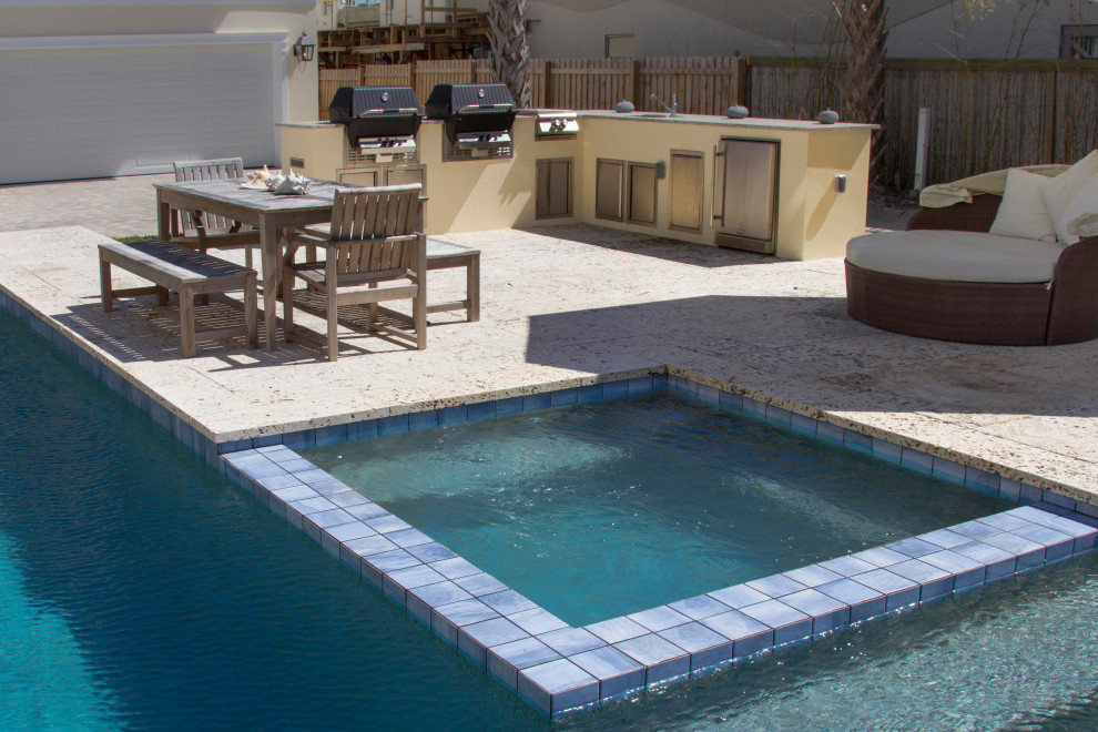 Photo of a modern l-shaped lap pool in Orlando with a hot tub.