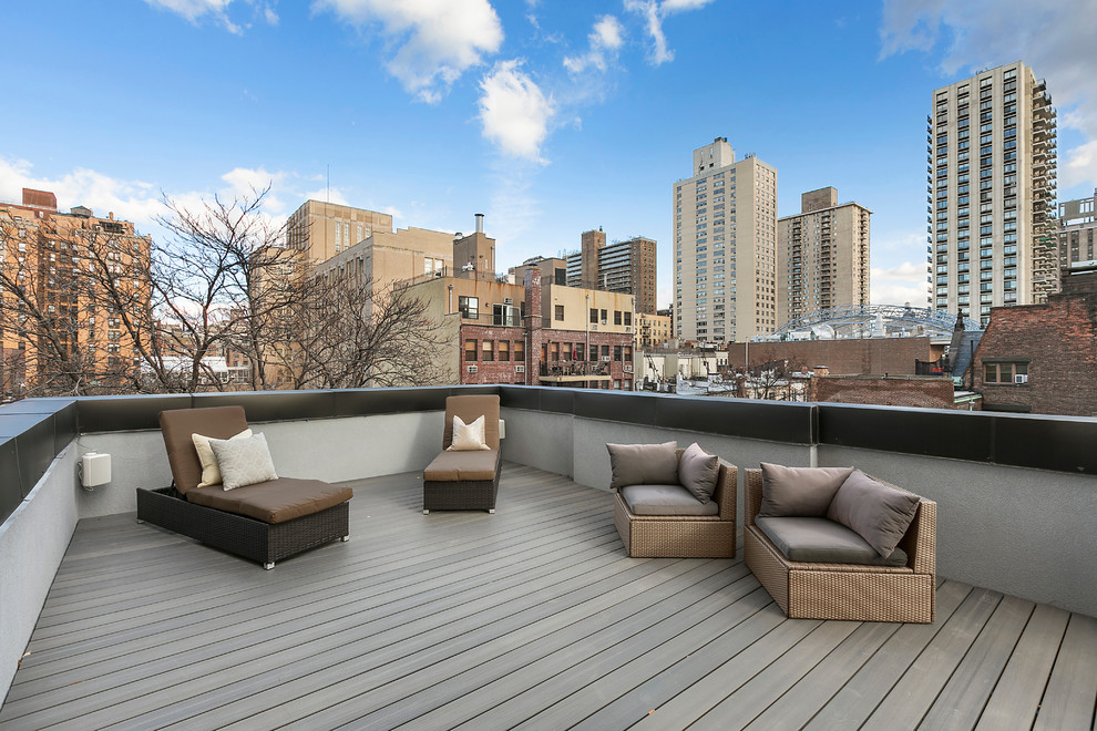 Large transitional rooftop deck photo in New York with no cover