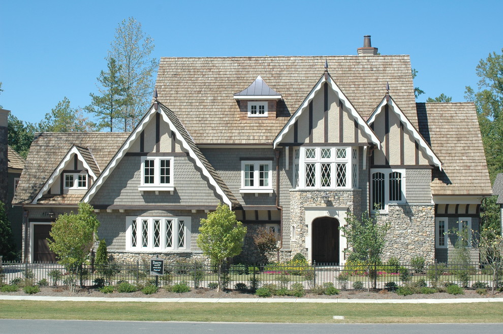 Photo of a large traditional two-storey grey exterior in Charlotte with mixed siding and a gable roof.