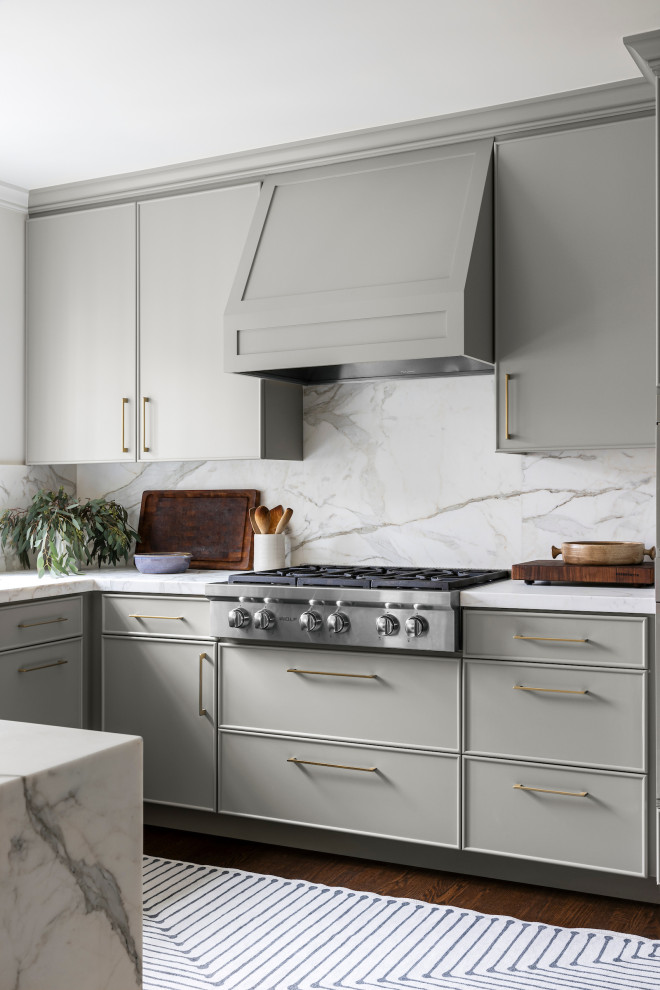 Mid-sized transitional u-shaped separate kitchen in San Francisco with a farmhouse sink, raised-panel cabinets, grey cabinets, marble benchtops, white splashback, marble splashback, stainless steel appliances, medium hardwood floors, a peninsula, brown floor and white benchtop.