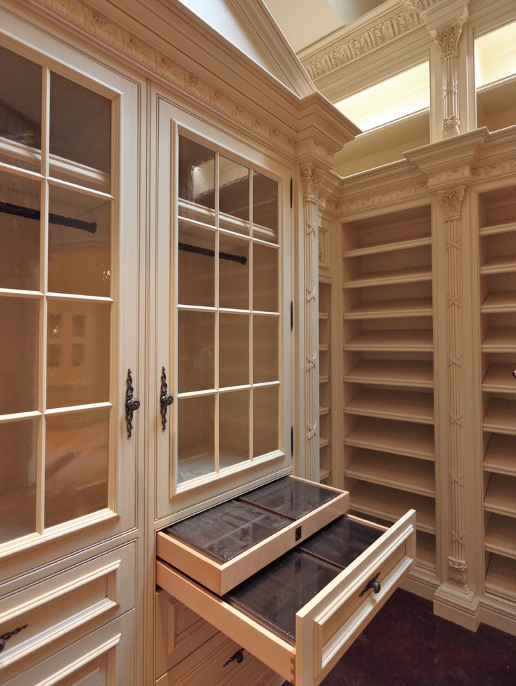 Inspiration for an expansive traditional women's walk-in wardrobe in St Louis with dark hardwood floors.