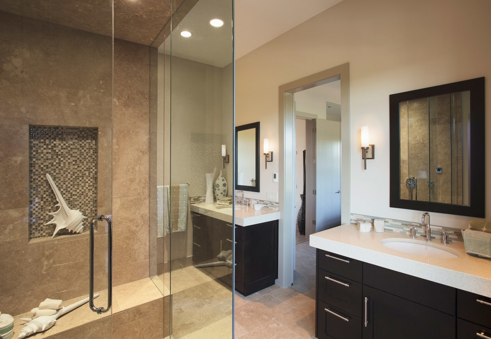 Design ideas for a mid-sized contemporary master bathroom in Calgary with shaker cabinets, dark wood cabinets, a corner shower, beige walls, ceramic floors, an undermount sink, solid surface benchtops, brown floor and white benchtops.