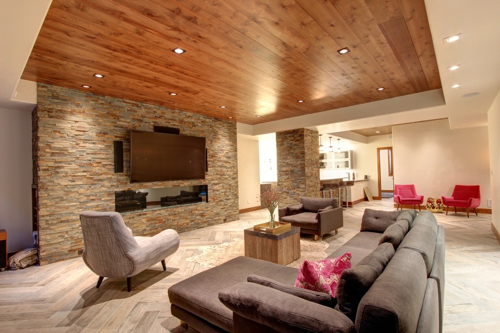 Design ideas for a large midcentury fully buried basement in Denver with white walls, light hardwood floors, a ribbon fireplace and a stone fireplace surround.