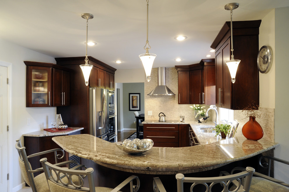 Example of a large transitional u-shaped ceramic tile and beige floor eat-in kitchen design with a double-bowl sink, shaker cabinets, dark wood cabinets, granite countertops, beige backsplash, mosaic tile backsplash, stainless steel appliances and a peninsula