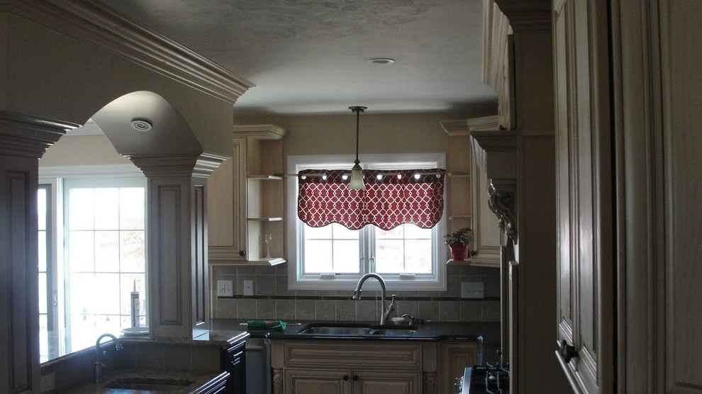 Open concept kitchen - mid-sized l-shaped open concept kitchen idea with light wood cabinets, onyx countertops, beige backsplash, ceramic backsplash, stainless steel appliances, a double-bowl sink and an island