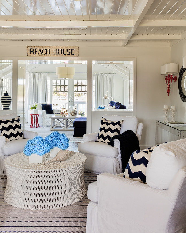 This is an example of a beach style living room in Boston with white walls.