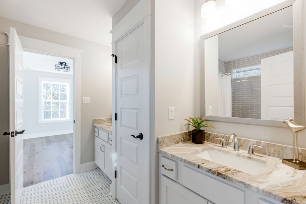 Photo of a mid-sized traditional kids bathroom in Richmond with recessed-panel cabinets, white cabinets, an alcove tub, a shower/bathtub combo, a two-piece toilet, ceramic tile, grey walls, ceramic floors, an undermount sink, granite benchtops, white floor, a shower curtain, brown benchtops, a double vanity and a built-in vanity.
