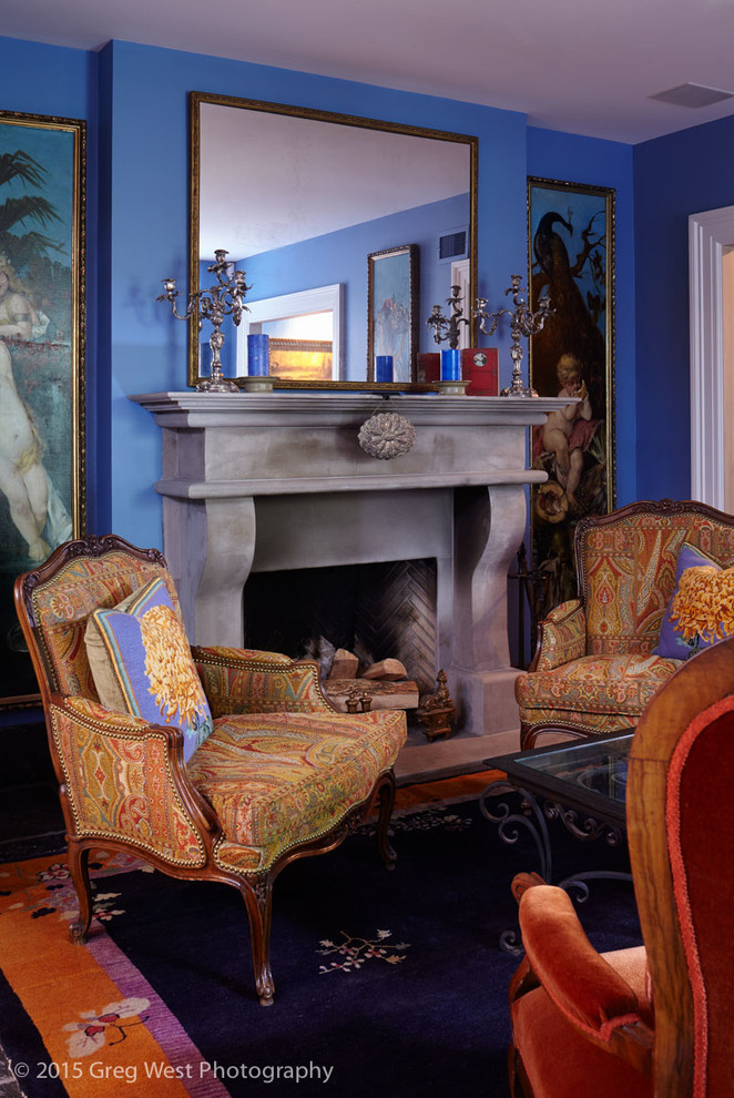 Photo of a mid-sized eclectic formal open concept living room in Boston with blue walls, a standard fireplace, a concrete fireplace surround and no tv.
