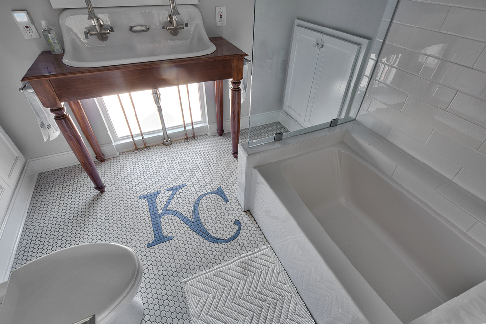 Design ideas for a small country kids bathroom in Kansas City with a drop-in sink, white cabinets, wood benchtops, a drop-in tub, a shower/bathtub combo, white tile, ceramic tile, grey walls and ceramic floors.
