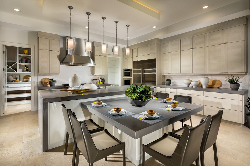 Photo of a large contemporary eat-in kitchen in Orange County with flat-panel cabinets, beige cabinets, quartz benchtops, white splashback, ceramic splashback, stainless steel appliances, limestone floors, with island, beige floor and grey benchtop.