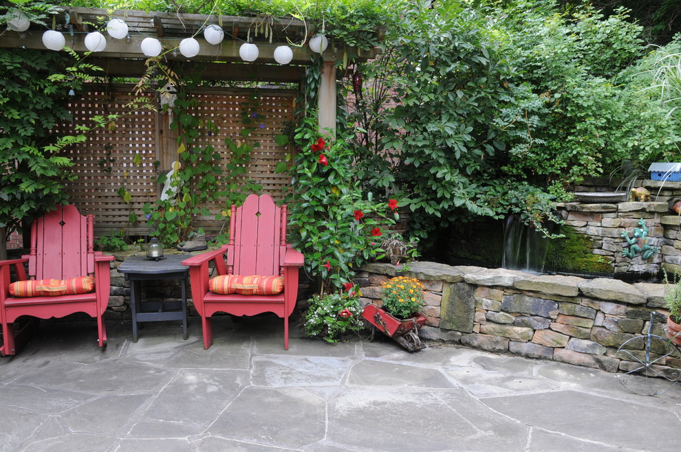 Traditional patio in Other with a water feature.