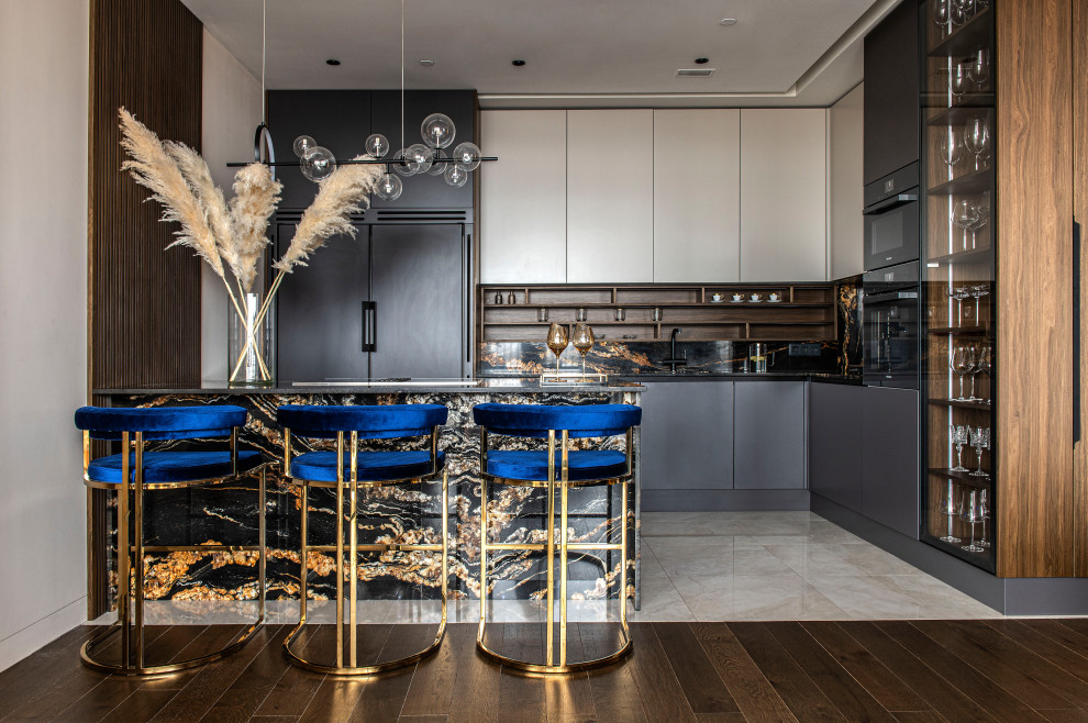 This is an example of a contemporary kitchen in New Orleans with flat-panel cabinets, beige cabinets, multi-coloured splashback, integrated appliances and a breakfast bar.