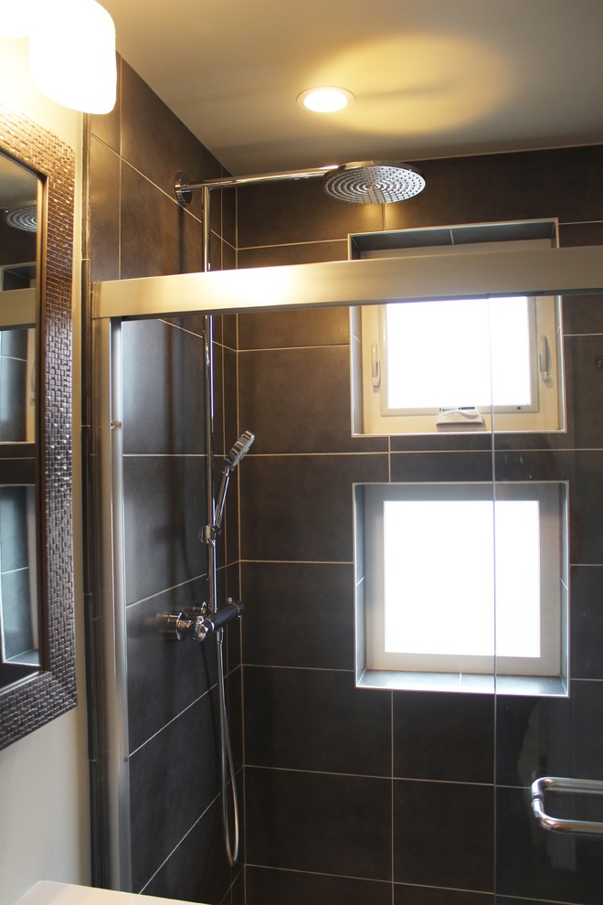 This is an example of a mid-sized contemporary master bathroom in Baltimore with white cabinets, a one-piece toilet, black tile, ceramic tile, grey walls, ceramic floors and a pedestal sink.