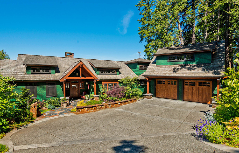 Inspiration for an arts and crafts two-storey green exterior in Seattle with wood siding.