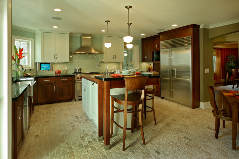 Large transitional u-shaped limestone floor eat-in kitchen photo with a farmhouse sink, shaker cabinets, white cabinets, wood countertops, blue backsplash, glass tile backsplash, stainless steel appliances and beige walls