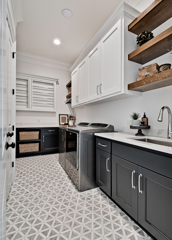 Large arts and crafts galley dedicated laundry room in Other with an undermount sink, raised-panel cabinets, white cabinets, quartzite benchtops, white splashback, engineered quartz splashback, white walls, porcelain floors, a side-by-side washer and dryer, grey floor and white benchtop.