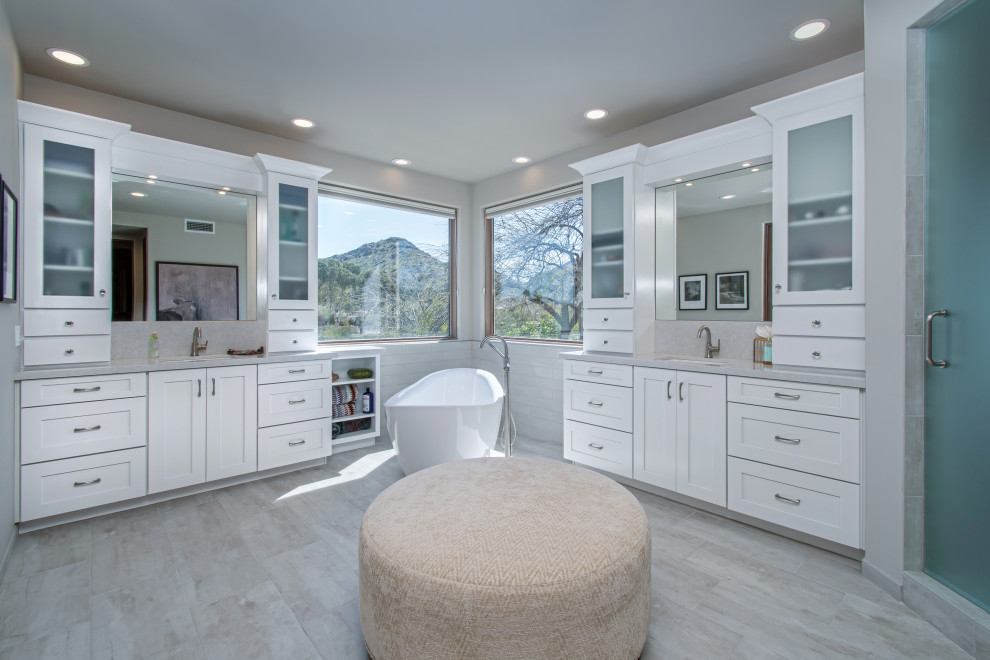 Design ideas for a large transitional master bathroom in Phoenix with shaker cabinets, white cabinets, a freestanding tub, white tile, porcelain tile, grey walls, porcelain floors, quartzite benchtops, grey floor, grey benchtops, a double vanity, a built-in vanity and an undermount sink.