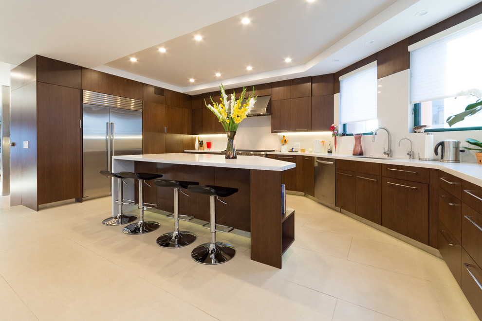 Mid-sized minimalist u-shaped ceramic tile eat-in kitchen photo in Los Angeles with a double-bowl sink, flat-panel cabinets, dark wood cabinets, soapstone countertops, white backsplash, stone tile backsplash, stainless steel appliances and an island
