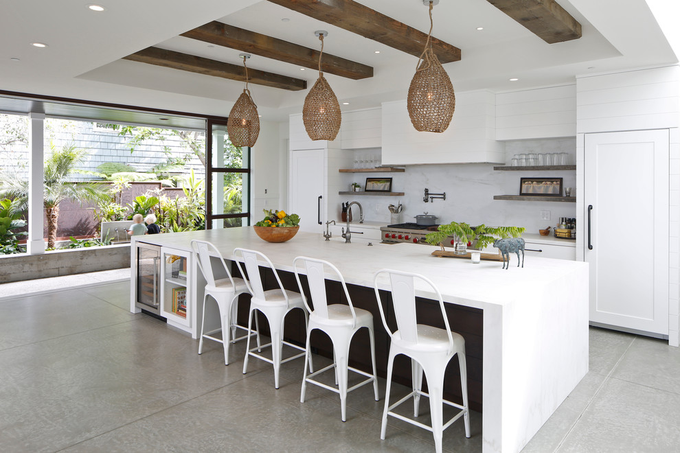 Country kitchen in San Diego with open cabinets, white splashback, stainless steel appliances and with island.