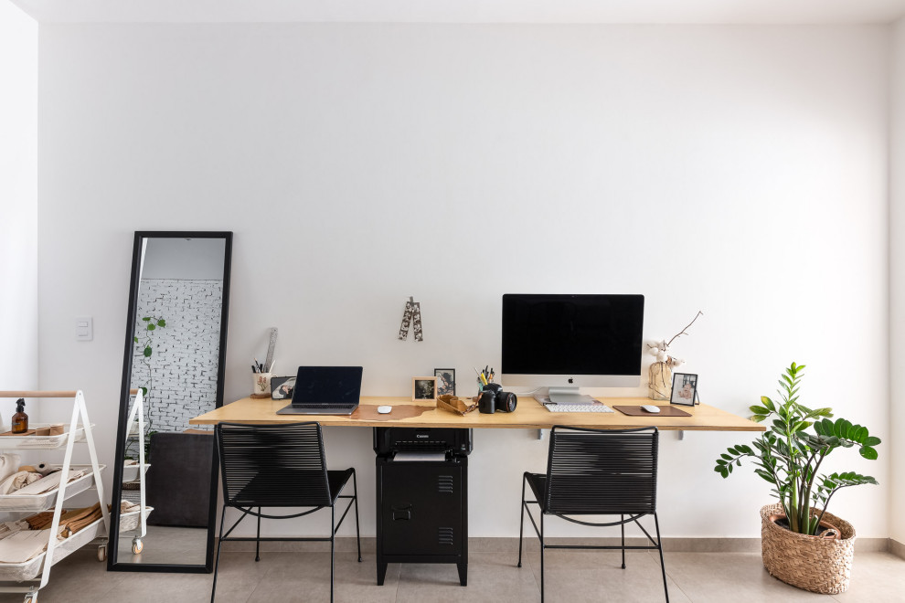 Idéer för ett industriellt arbetsrum, med vita väggar, klinkergolv i porslin, ett fristående skrivbord och grått golv