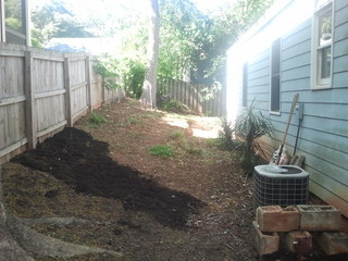 Side yard slopes towards house