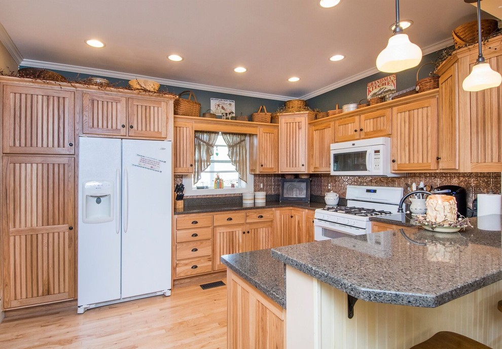 Mid-sized mountain style u-shaped light wood floor and brown floor eat-in kitchen photo in Cincinnati with a farmhouse sink, recessed-panel cabinets, light wood cabinets, granite countertops, metallic backsplash, ceramic backsplash, white appliances, a peninsula and gray countertops