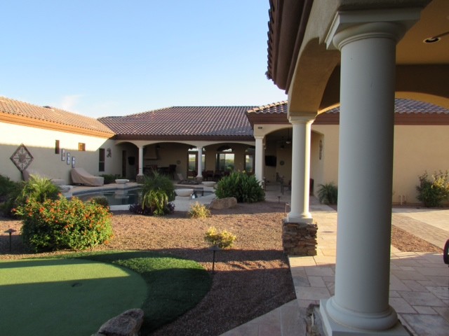 This is an example of a large mediterranean one-storey beige exterior in Phoenix.