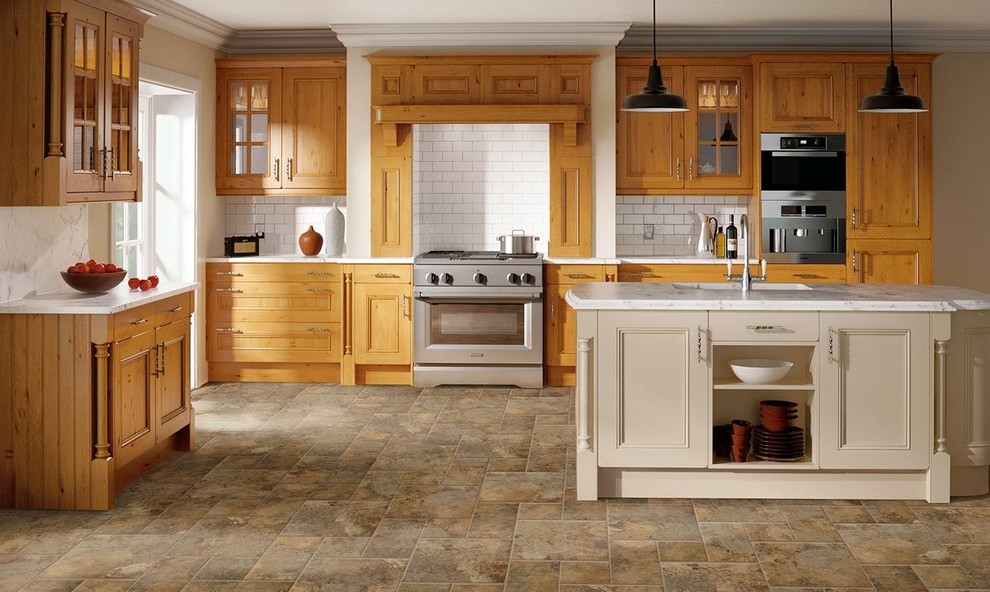 Kitchen - mid-sized ceramic tile and brown floor kitchen idea with an undermount sink, recessed-panel cabinets, medium tone wood cabinets, white backsplash, subway tile backsplash, stainless steel appliances and an island