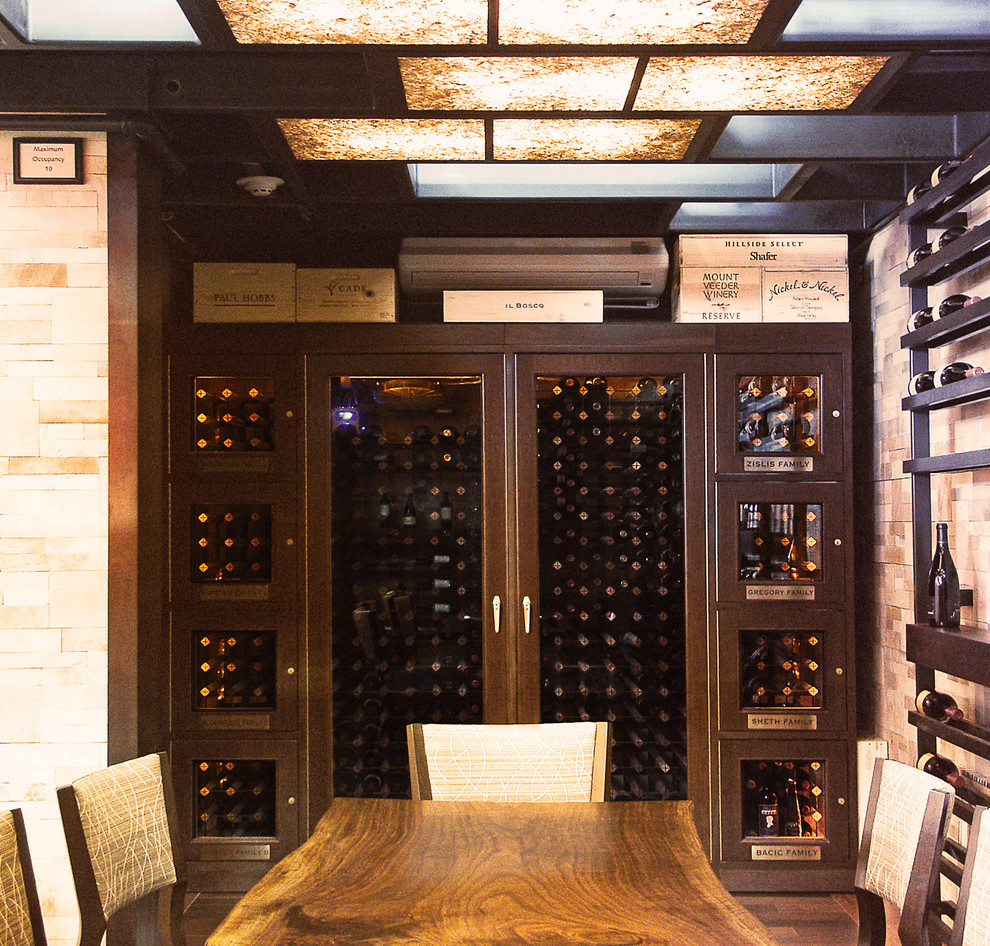 Photo of a large modern wine cellar in Los Angeles with brick floors, storage racks and red floor.
