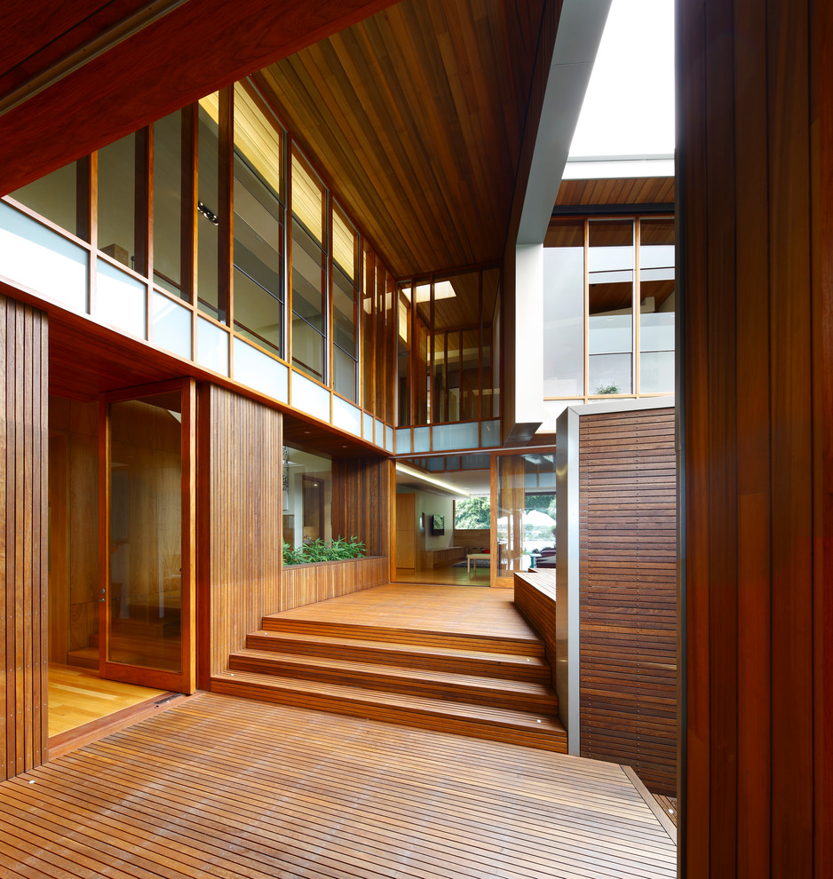 Large contemporary front door in Brisbane with light hardwood floors, a single front door and a light wood front door.