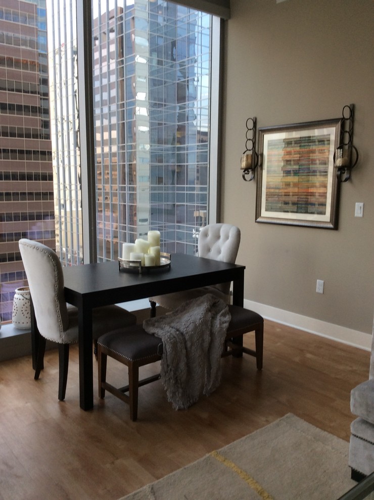 Small contemporary dining room in Phoenix with beige walls, light hardwood floors and no fireplace.